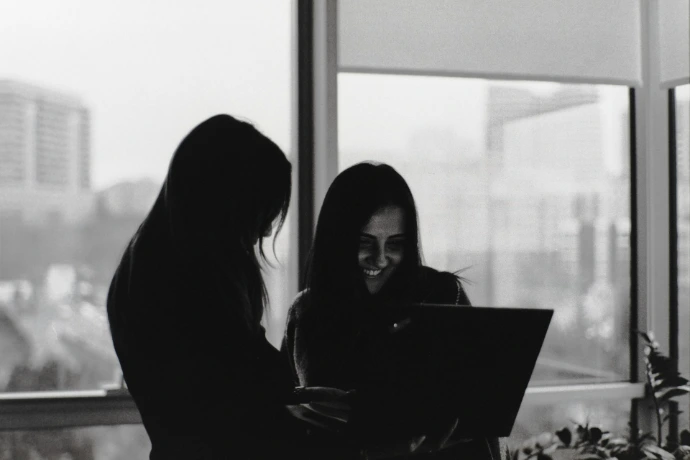 Two women looking at a laptop screen